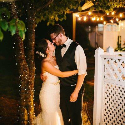 A kiss for the newlyweds under our newly lit fairy light tree