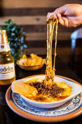 Let your tastebuds melt away with our delicious Queso Fundido topped with Chorizo