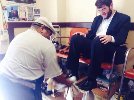 Adam Kodin from Metro Realty getting his shoes shined at Andy's.