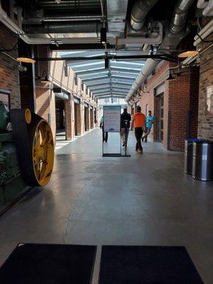 Looking down the hall from the parking lot you can enter to the right or to the left there are shops on both sides