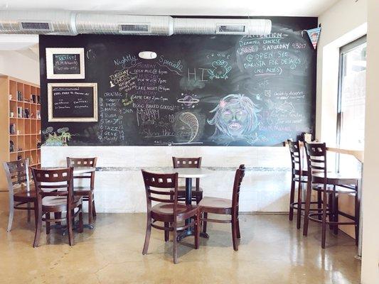 Big chalkboard wall and indoor seating.