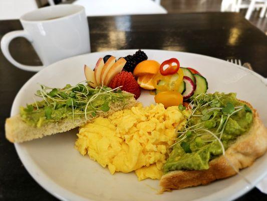 Avocado Toast and Eggs with house made sourdough toast, soft scrambled eggs, and fresh fruit