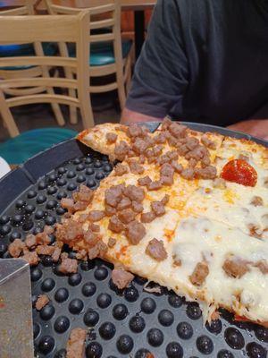 Sausage dumped on top of pizza instead of making a new one.