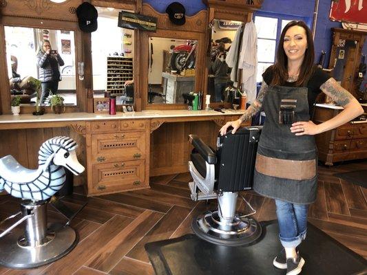 Brooke in front of a Victorian era custom breakfront fitted to accommodate the barbering equipment