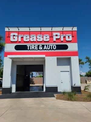 Tire & Auto building with lift for automotive repair.