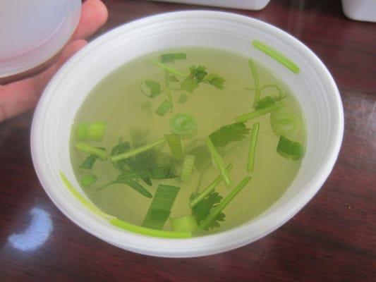 Complimentary broth with cilantro and scallions.