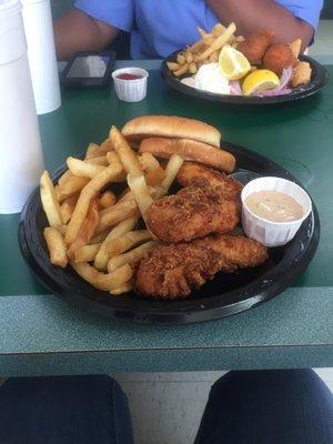 Chicken tender basket with a side of roosters sauce