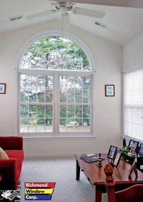 Renewal by Andersen, double hung window with circle top, white interior, and colonial grilles