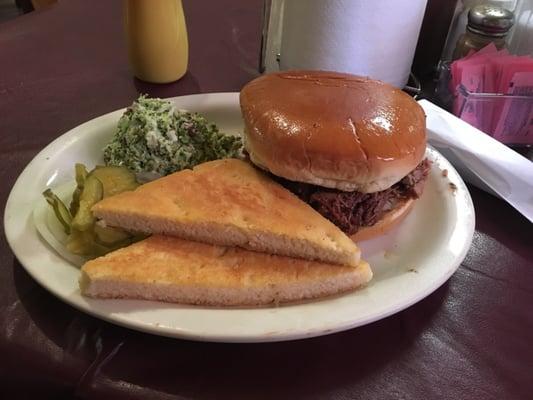 Chopped brisket sandwich with broccoli slaw and pan de campo.