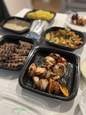 Family style:  honey chicken kabobs, "kafta" (beef kabobs), Big O's Hummus, Israeli salad, turmeric rice, tzatziki and lemon garlic sauce.