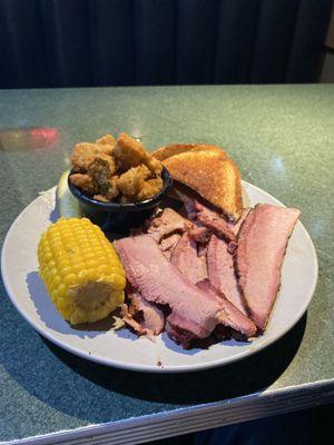 Sliced brisket plate with corn and okra.