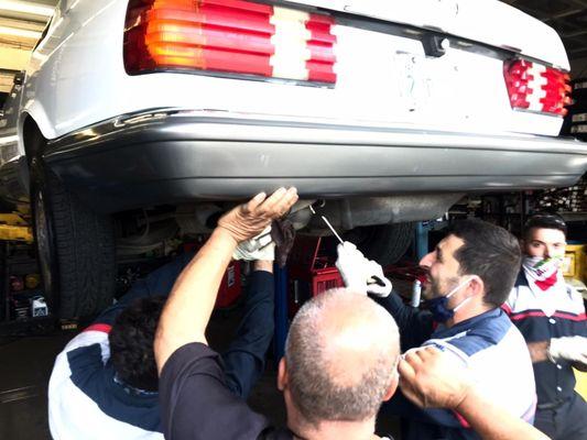 Staff installing the exhaust rubber donuts to support the muffler as per Mercedes specifications.