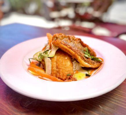 Beer battered fish on top of a cilantro lime rice