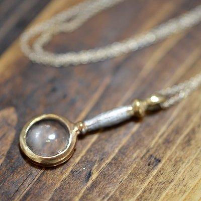 Tiny magnifying glass necklace.