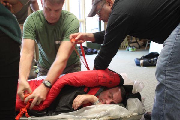 Wilderness First Responder students practicing a rescue of a hypothermia victim.