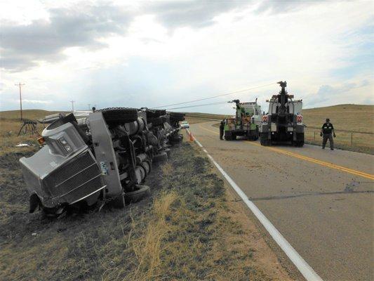 Two of our heavy duty wreckers righting a semi truck.