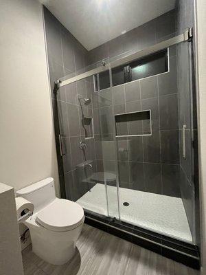 Toilet, shower fixtures and shower door from Bathroom Store