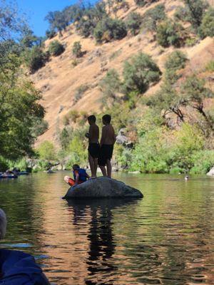 Kids swimming at the swimming hole.