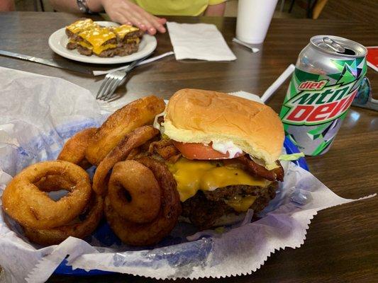 Double bacon cheeseburger deluxe with onion rings.