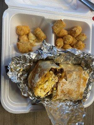 Claire's Texas burrito with egg, chorizo ,Beans swapped American cheese to provolone and brekkie sauce... delish... can't forget the tots