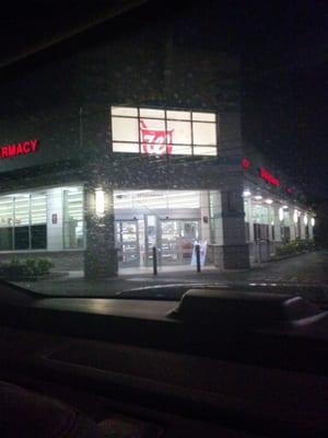 The store from the outside at night.