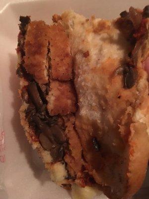 Chopped up processed chicken patty inside chicken parmigiana