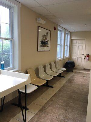 A shelf mounted on this wall with regular chairs would provide a place for patrons to work on laptops while waiting for their laundry.