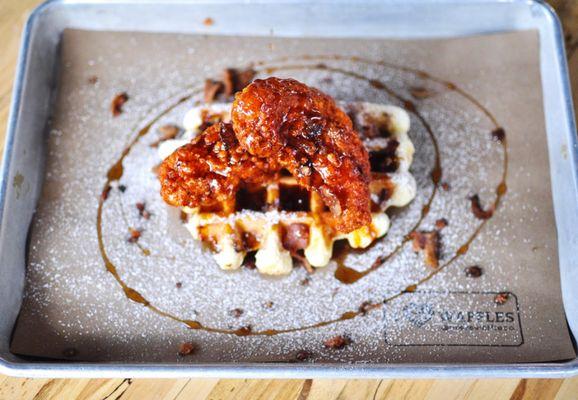 Nashville hot chicken and waffles. Waffle topped with Two deep fried chicken tenders tossed in spicy Nashville hot sauce