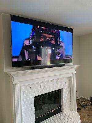 TV Installed above Fireplace.