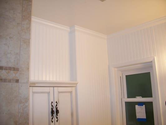 Install beadboard floor to ceiling with crown molding.