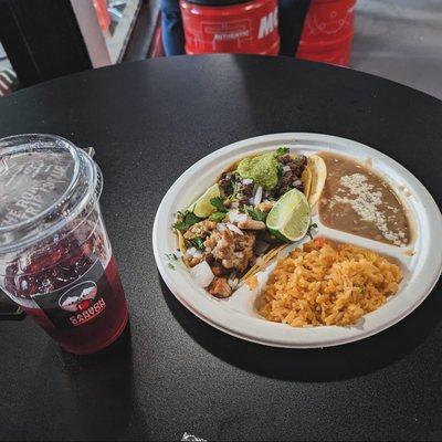 Al Pastor and Asada tacos paired with a refreshing Jamaica drink.