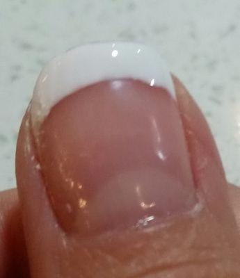 The yellowish base coat he spilled on the left side of my nail leaving the stain.