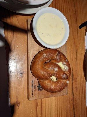 Soft pretzel with cheese sauce