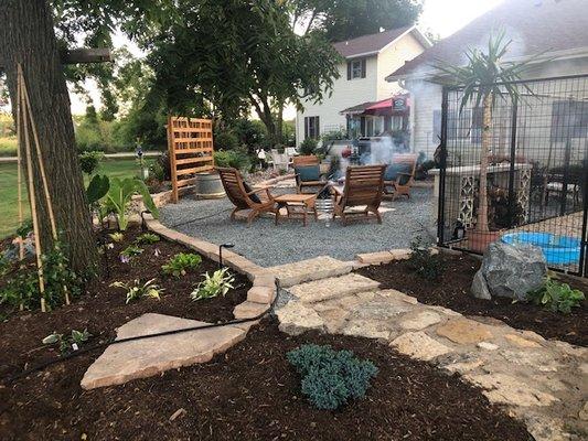 Rear view with Mulch bed to stone patio.  We also built the decorative wood divider panel