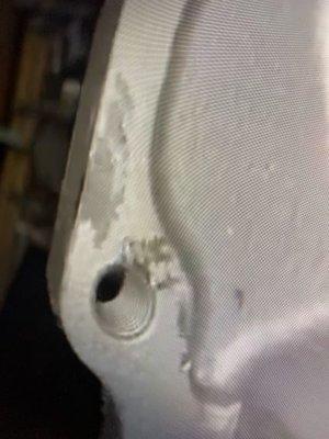 Hammer marks and uneven surfaces on the cylinder head.