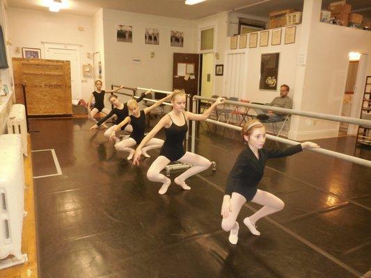 Intermediate students studying at the barre