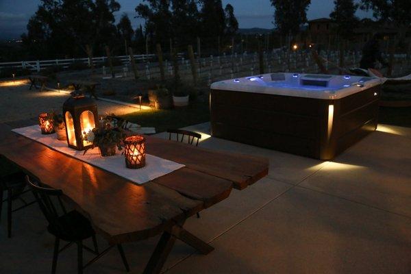 Sundance Spas 880 Series installation at night with spa lights.