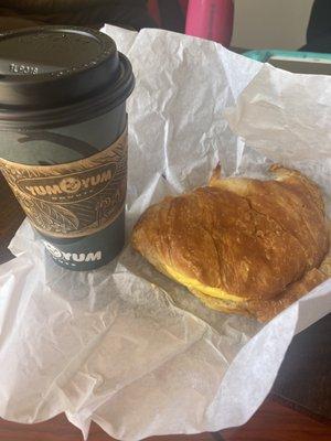 Coffee and croissant sandwich