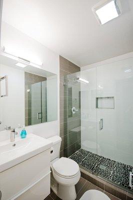 Custom frameless mirror and shower enclosure by Green's.