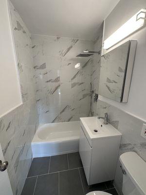 Here is another beautiful full gut renovation. We installed a ceramic tile that somewhat mimics marble tiles.