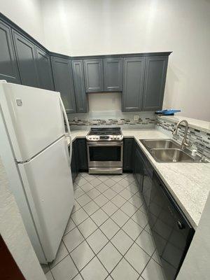 Modern kitchen remodel: replaced all the cabinets, countertops, put in a new sink, faucet, water filter, and backsplash.