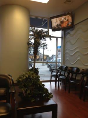 Nice waiting area with two televisions and a view of Airline Drive with Applebees across the street.