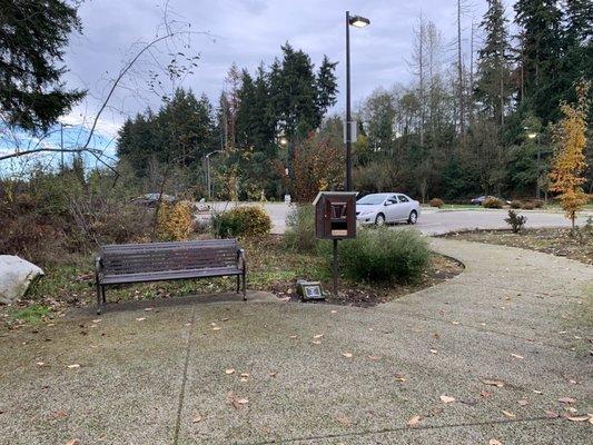 Parking lot beyond the bench.