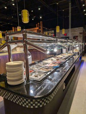 Buffet table with all the veggies and seafood options