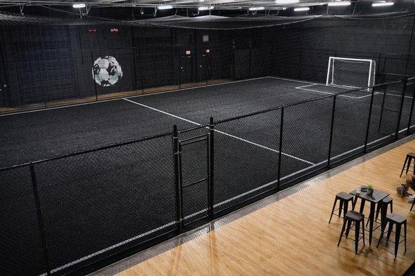 Fully air conditioned indoor soccer facility with premium black turf field.