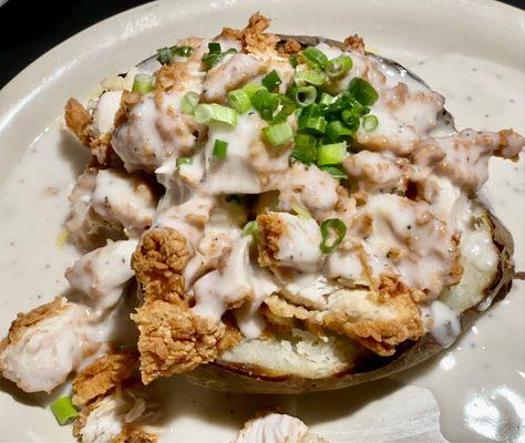 Chicken fried chicken spud, cream gravy, topped with green onions.