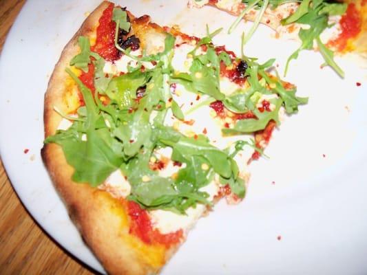 Pizza Claudia- Tomato sauce, fresh mozzarella, sun dried tomatoes, arugula and a touch of garlic oil