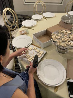 Me, in my evening dress, 30 min until guests arrive, trying to glue crosses to chocolates. Having fun, trying to fix Mirelli's sloppy job.