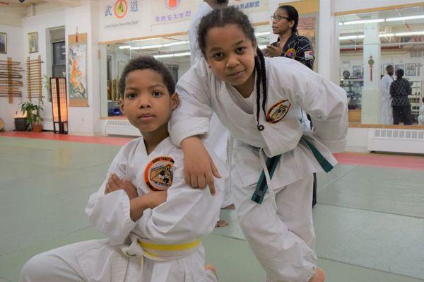 Martial arts children train together.