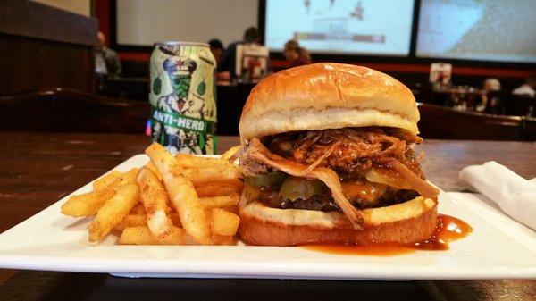 A "Build Your Own" Burger topped with Pulled Pork, Pickles and Cheddar